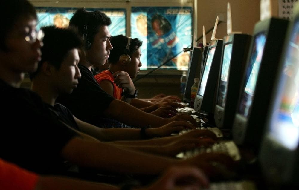 Chinese youths use computers at an Internet cafe in Beijing in June 2005. (AP Photo/Greg Baker)