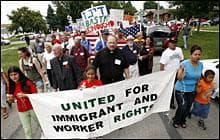 An immigration rally on July 27, 2008, in Postville, Iowa, held in protest of a federal immigration raid of the local Agriprocessors plant in May. (AP Photo/Charlie Neibergall)
