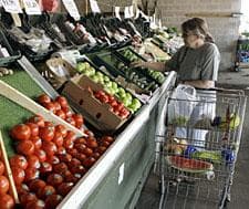 A shopper looks for fruits and vegetables at Eastern Market in Detroit, Mich. in July 2008. (AP Photo/Paul Sancya)