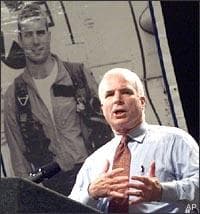 Sen. John McCain in front of a portrait of himself as a fighter pilot.  (AP)