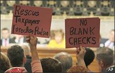 Protesters hold up signs on Capitol Hill in Washington, during a Senate Banking Committee hearing. (AP)
