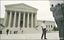 Security guards stand on the steps of the Supreme Court. (AP)