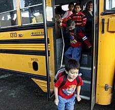 This Sept. 4, 2007 photo shows children unloading off the bus at Eugene Field Elementary School in Silverton, Ore. (AP Photo/Statesman Journal, Lori Cain)