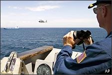 U.S. Navy cruiser monitors a pirated ship. (AP)