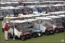 Patrons of The Villages Gridiron Classic, left, get out of there golf cart among hundreds of others before the start of game on Saturday, Jan. 15, 2005 in The Villages, Fla. The game is held inside a retirement community drawing from large number of attendees who travel to the game by golf cart. (AP)