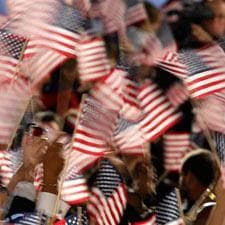 The crowd waves U.S. flags as it is announced on television that Barack Obama has been elected the President of the United States at his election night party at Grant Park in Chicago, Tuesday night, Nov. 4, 2008. (AP Photo/Morry Gash)