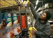 Lisa Hale, a volunteer with the Capital Area Food Bank, stocks shelves at the food bank in Washington, Monday, Oct. 27, 2008. Calls to the Capital Area Food Bank's Hunger Lifeline, an emergency food referral system in Washington, D.C., increased 248 percent in the past six months versus last year, said spokeswoman Kasandra Gunter Robinson. (AP)