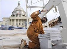 With the Capitol in the background, a worker, who asked not to be named, paints the center stand of the inaugural platform, at the west front of the Capitol in Washington, on Thursday, Dec. 4, 2008, as preparation continues for Barack Obama's inauguration on Jan. 20, 2009. (AP)