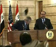 In this image from APTN video, a man throws a shoe at President George W. Bush during a news conference with Iraq Prime Minister Nouri al-Maliki on Sunday, Dec. 14, 2008, in Baghdad. (AP Photo/APTN) 