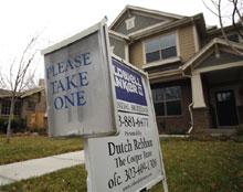 A realty sign stands outside a new home for sale in southeast Denver on Thursday, Nov. 20, 2008. (AP Photo/David Zalubowski)