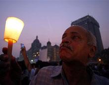 An elderly man joins some hundreds of others to light candles in memory of people killed in the recent terror attacks outside the Taj Mahal hotel in Mumbai, India, Wednesday, Dec. 3, 2008. (AP Photo/Saurabh Das)