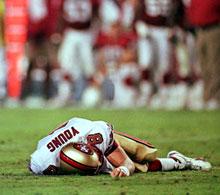 San Francisco 49ers' quarterback Steve Young lays motionless on field after suffering a concussion in the second quarter of the 49ers' game against the Arizona Cardinals Monday Sept. 27, 1999 in Tempe, Arizona. (AP Photo/Scott Troyanos)