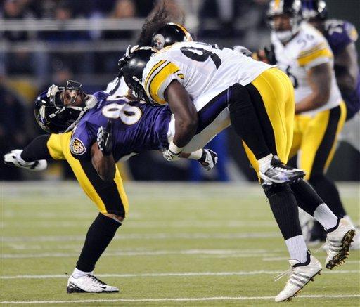 Baltimore Ravens wide receiver Derrick Mason is hit by Pittsburgh Steelers linebacker Lawrence Timmons. AP Photo.