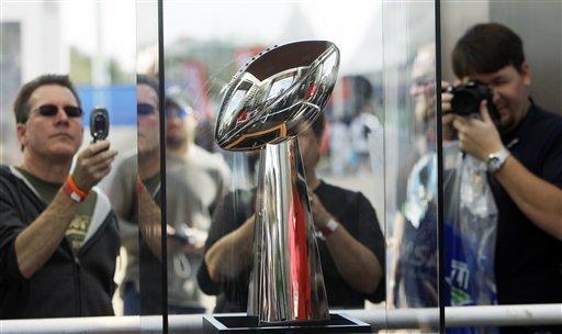 Fans take pictures of the Vince Lombardi trophy at the NFL Experience as part of Super Bowl XLIII Saturday, Jan. 24, 2009, in Tampa, Fla. AP Photo.