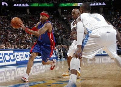 Detroit Pistons guard Allen Iverson works the ball inside for a shot past Denver Nuggets guards J.R. Smith and Chauncey Billups on Jan. 9, 2009. Billups and Iverson were traded for each other in November of 2008. AP Photo.