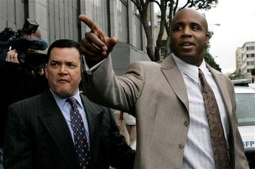 Former San Francisco Giants baseball player Barry Bonds (right) leaves a federal courthouse in January. Bonds is charged with lying to a December 2003 grand jury when he said he never knowingly used performance-enhancing drugs. (AP Photo)