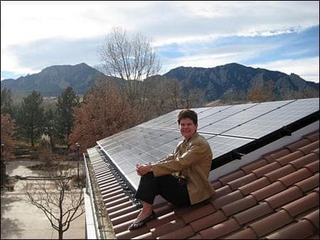 Val Peterson on top of the Chancellor's Residence at University of Colorado-Boulder, where the house has been retrofitted with solar panels as part of the Smart Grid project. (Photo courtesy Val Peterson)