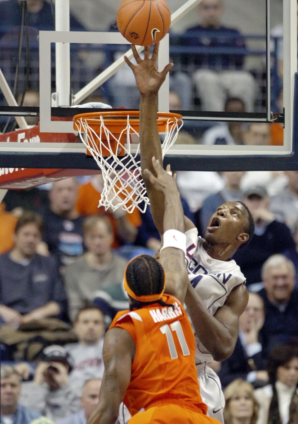 Connecticut's Hasheem Thabeet, right, blocks the shot of Syracuse's Paul Harris during the NCAA college basketball game in Conn., on Feb. 11, 2009.  (AP)