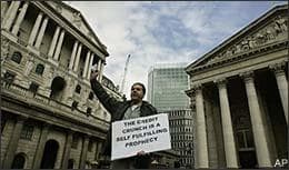 Ahead of the G20 summit, a lone protester delivers a speech on the financial issues, back dropped by the Bank of England, left, and the Royal Exchange, right, in central London's City financial district, Tuesday March 31, 2009. World leaders are gathering in London for the Group of 20 summit amid an unprecedented security operation to protect the meeting from possible violent protests. (AP)