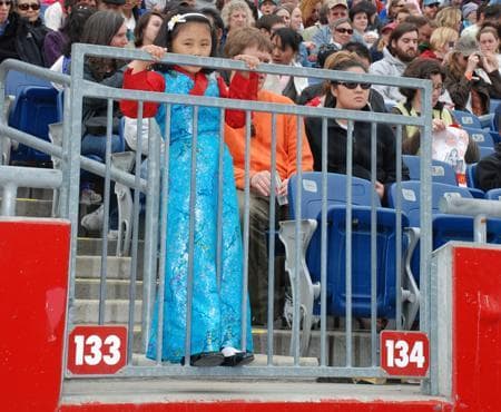 A young eventgoer peers over the railing for a better look. (Lisa Tobin/WBUR)
