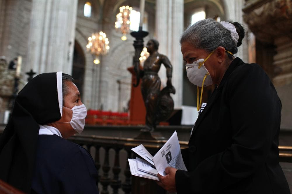Catholic nuns wearing masks as a precaution against swine flu prepare for mass at the Metropolitan Cathedral in Mexico City, Sunday, May 3, 2009. (AP)