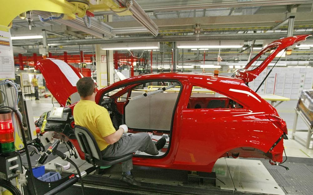 A worker assembles an Opel Corsa car at the Opel car factory, owned by General Motors Corp., in Eisenach, Germany, on Monday, May 4, 2009. Fiat Group SpA's chief executive was expected in Berlin for discussions Monday with the German government on the company's hopes of taking over General Motors Corp.'s Opel unit _ a prospect that has prompted skepticism among employee representatives.  (AP)