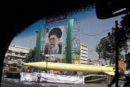 A military exhibition displays a Revolutionary Guard missile, the Shahab-3 missile, which is claimed to be capable of carrying a nuclear warhead and reaching Europe, Israel and U.S. forces in the Middle East, seen under a picture of the Iranian supreme leader Ayatollah Ali Khamenei, in Tehran, Iran, on Tuesday Sept. 23, 2008. The display is to mark the 28th anniversary of the onset of the Iran-Iraq war (1980-1988). (AP)