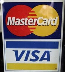 Credit card advertisements posted at a bowling alley in Palo Alto, Calif., Wednesday, July 30, 2008. Visa Inc. says its profit rose a better-than-expected 41 percent in the most recent quarter, as more money changed hands using its credit and debit cards. (AP)