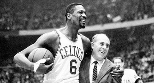 In this Dec. 12, 1964 file photo, Boston Celtics' Bill Russell, left, is congratulated by coach Arnold &quot;Red&quot; Auerbach after scoring his 10,000th career point during a basketball game against the Baltimore Bullets at the Boston Garden in Boston. As a coach, Red Auerbach got the most out of Bill Russell as a player not by yelling at him, or teaching him new techniques. He just talked to him man-to-man. Russell celebrates their relationship in a new book about Auerbach. (AP)