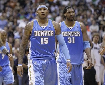 Denver Nuggets forward Carmelo Anthony (15) and Denver Nuggets center Nene (31), of Brazil, walk down the court in the closing seconds against the Dallas Mavericks in the second half of Game 4 of the NBA basketball Western Conference semifinal, Monday, May 11, 2009, in Dallas. Dallas won 119-117. (AP Photo/Matt Slocum)