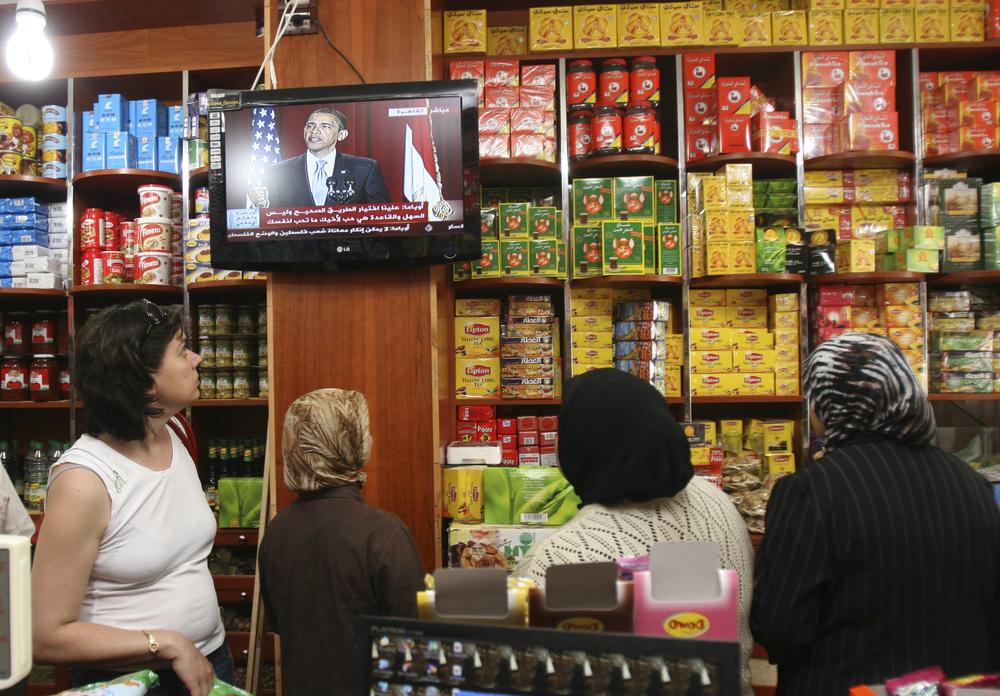 Women watch the speech of U.S. President Barack Obama as they stand in a spice shop in the shouthern port city of Sidon, Lebanon, Thursday, June 4, 2009. Obama called for a new beginning between the United States and Muslims, during his speech delivered at Cairo University, Egypt, on Thursday, which is broadcast live on the internet and TV stations. (AP)