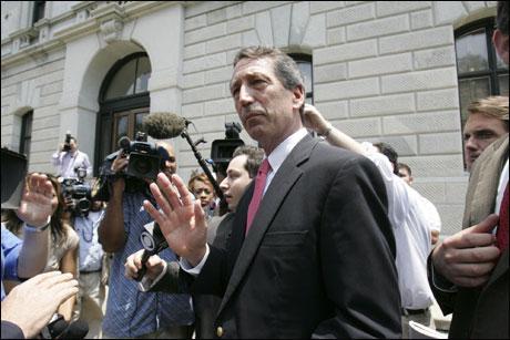 South Carolina Gov. Mark Sanford tries to keep the media back as he makes his way to the Statehouse after a cabinet meeting Friday in Columbia, S.C. (AP Photo)
