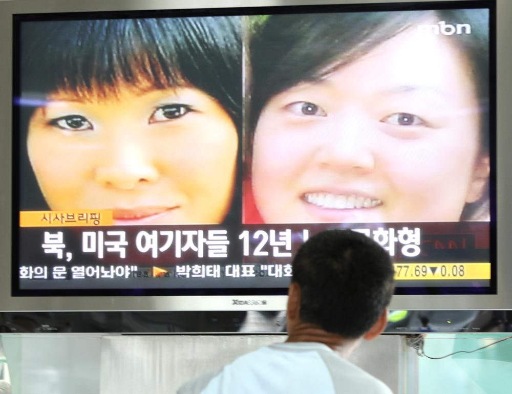 A South Korean man watches a TV broadcasting news about two American journalists detained in North Korea at the Seoul Railway Station, in South Korea, Monday, June 8, 2009. North Korea's top court convicted the journalists and sentenced them to 12 years in a prison Monday, intensifying the reclusive nation's confrontation with the United States. The headline reads &quot;North Korea convicted two American journalists and sentenced them to 12 years in a prison.&quot; (AP Photo/Ahn Young-joon)