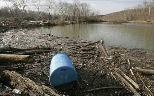 A plastic 55 gallon barrell is seen amongst piles of driftwood and mud along the Potomac River in Cropley, Md., Wednesday, Feb. 8, 2006. Last year, volunteers removed nearly 218 tons of such trash from the Potomac watershed in a single day. Now the group that sponsors the annual cleanup has a new goal: a trash-free Potomac by 2013. Aided by the World Bank, the Chesapeake Bay Trust and some Yale University graduate students, the Alice Ferguson Foundation is pressing every municipality in the Potomac's four-state watershed to participate in a regional effort to banish litter from &quot;the nation's river.&quot; (AP Photo/Chris Gardner)