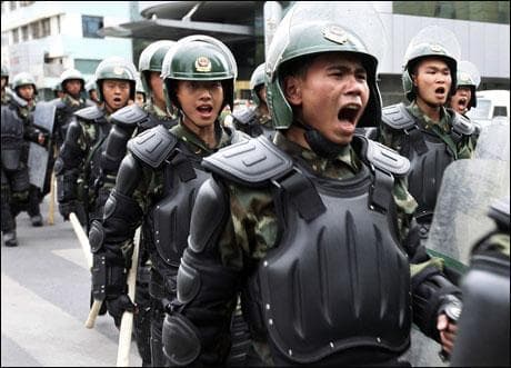 Chinese paramilitary police patrol in Urumqi, the capital of western China's Xinjiang province, Wednesday. China flooded the capital with security forces after ethnic riots left at least 156 dead. (AP Photo) 