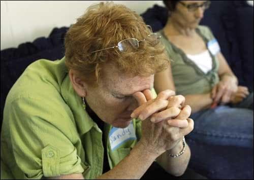 Two women pray during an unemployed support group meeting in Beverly, Mass. The group is one of several church-related unemployment support groups that have formed around the country. (AP)