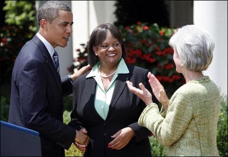President Barack Obama, left, congratulates Dr. Regina Benjamin, center, as Secretary of Health and Human Services Kathleen Sebelius applauds, following Obama's announcement of his nomination of Benjamin to the post of Surgeon General on Monday. (AP Photo)