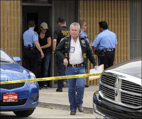 A Houston narcotics officer leaves Dr. Conrad Murray's Armstrong clinic where Los Angeles police and agents with the U.S. Drug Enforcement Administration were searching for documents Wednesday in Houston. (AP Photo)