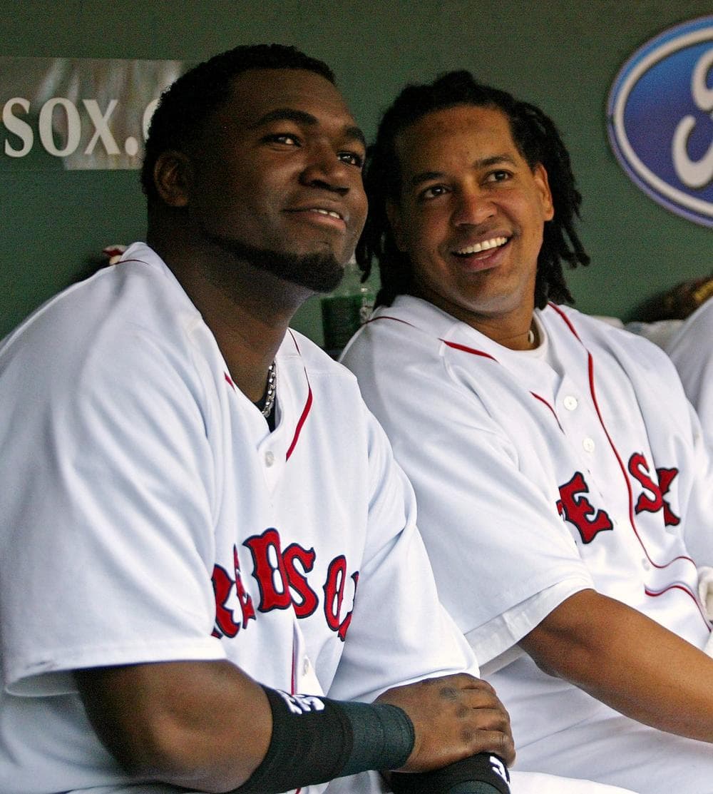 Boston Red Sox' Manny Ramirez, right, sits in the dugout with then-teammate David Ortiz during their game against the Minnesota Twins at Fenway Park on July 31, 2005. (AP Photo/Winslow Townson)