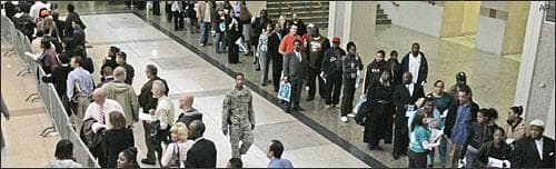 A line winds through the Cleveland Convention Center as people wait a job fair. May 2009. (AP)