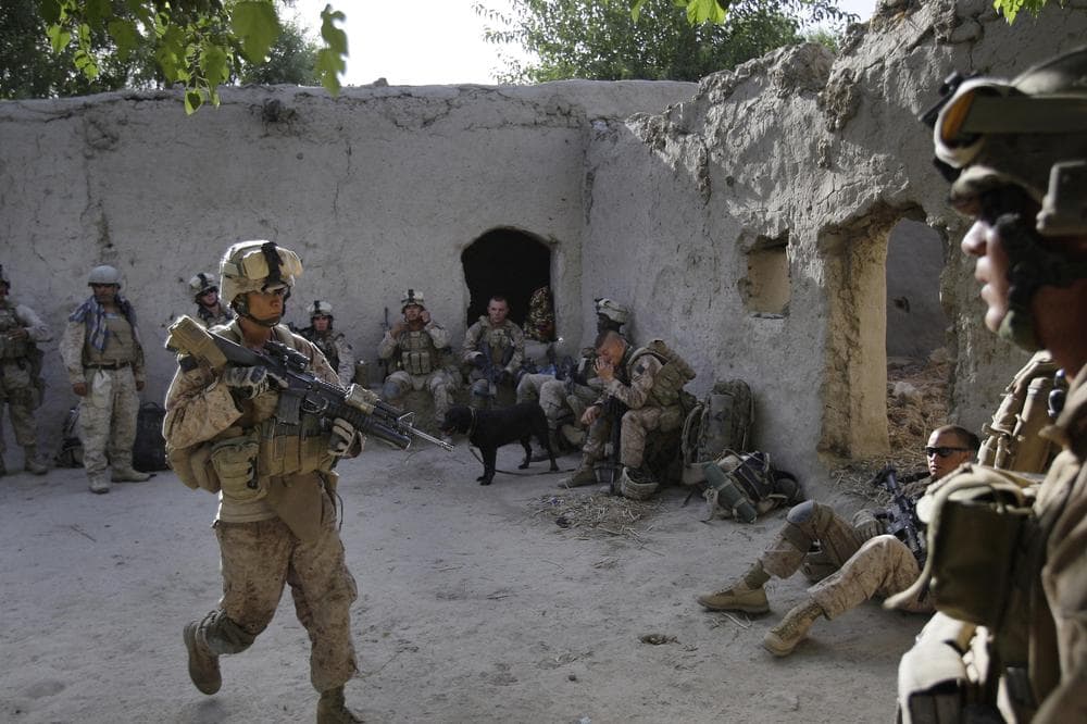 U.S. Marines from the 2nd Marine Expeditionary Brigade, 1st Battalion 5th Marines temporarily occupy a house after arriving in an overnight air assault near the Taliban stronghold of Nawa in Afghanistan's Helmand province Thursday July 2, 2009.   Thousands of U.S. Marines poured from helicopters and armored vehicles into Taliban-controlled villages in southern Afghanistan on Thursday in the first major operation under President Barack Obama's strategy to stabilize the country.  (AP Photo/David Guttenfelder)