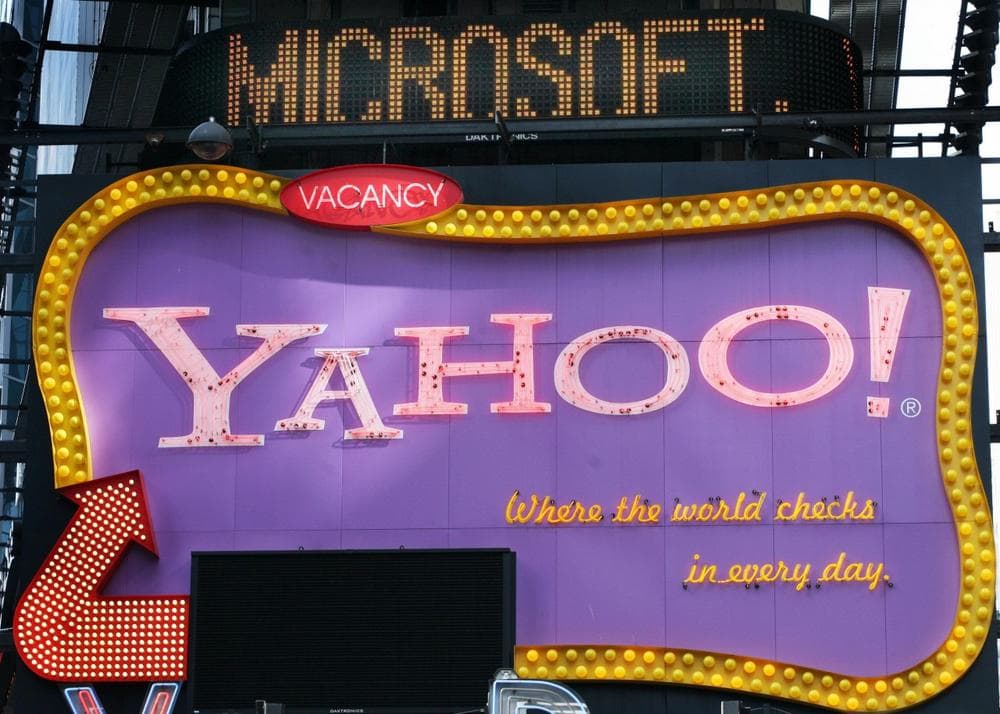 In this May 2007 file photo, a news ticker flashes a headline about Microsoft above a billboard for Yahoo in New York's Times Square. (AP Photo/Mark Lennihan)