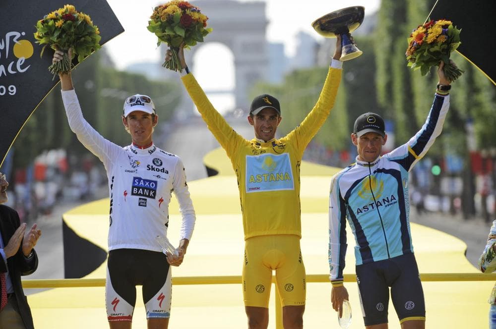 Andy Schleck of Luxembourg, wearing the best young rider's white jersey, second overall, Tour de France winner Alberto Contador of Spain, wearing the overall leader's yellow jersey, and third overall American seven-time Tour de France winner Lance Armstrong, left to right, react on the podium after the 21st stage of the Tour de France cycling race on Sunday. (AP Photo)