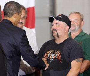 President Obama shakes hands with an audience member after speaking at Monaco RV Manufacturing in Wakarusa, Ind., Wednesday. (AP)