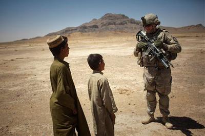 Afghan children with a U.S. soldier from the 5th Stryker Brigade on Monday as he patrols in Sari Ghundi village near the border with Pakistan, about 63 miles southeast of Kandahar. (AP)