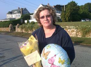 Anna Griswold brought flowers and a balloon to the Hyannisport neighborhood. (Steve Brown/WBUR)