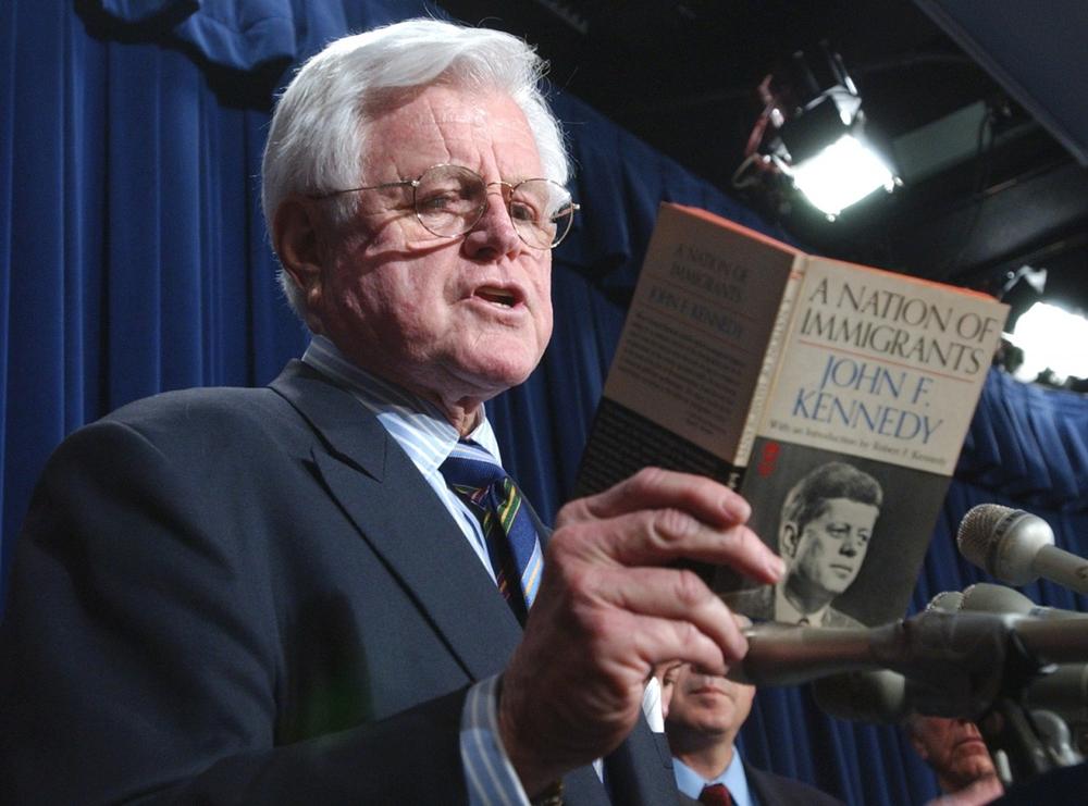 Sen. Edward M. Kennedy reads from a book written by his late brother, former President John F. Kennedy, entitled &quot;A Nation of Immigrants,&quot; during a news conference on Capitol Hill in April 2006 after the Senate failed to agree on an immigration bill.  (AP)
