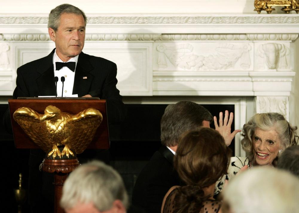 Shriver waves from her seat as President George W. Bush speaks at a dinner honoring the Special Olympics on July 10, 2006, at the White House. (AP)