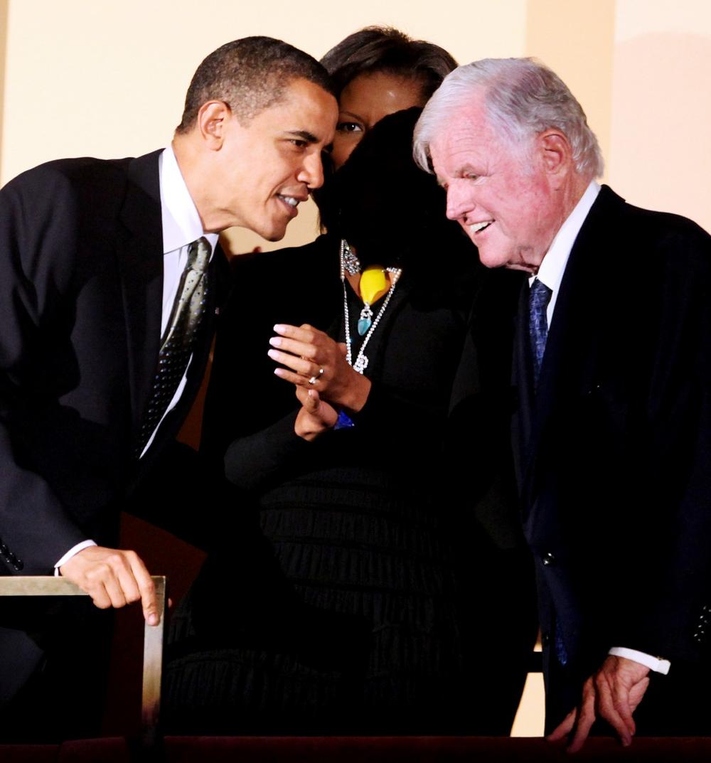 President Obama leans in front of first lady Michelle Obama as he talks to Sen. Edward Kennedy during a birthday salute to Kennedy at the John F. Kennedy Center for the Performing Arts in Washington. (AP)