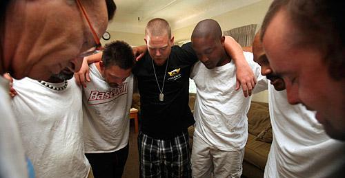 In this photo taken Wednesday, July 29, 2009, from left, Tim Plescia, Marvin Miller, David Elledge, Joseph Baker. Antoine Wade, Christopher Williams and Dustin Miller, gather in a circle for a serenity prayer at the end of a discussion group for drug and alcohol abusers at the Sacramento Recovery House, in Sacramento, Calif. (AP Photo/Rich Pedroncelli)